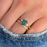 Green sapphire and diamond three-stone engagement ring stacked with wedding band