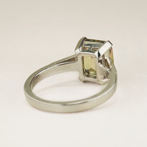 Green and brown colour-change sapphire solitaire engagement ring