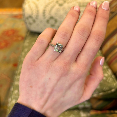 Green and brown colour-change sapphire solitaire engagement ring