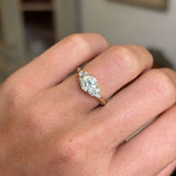 Diamond ring on a finger with a blurred background