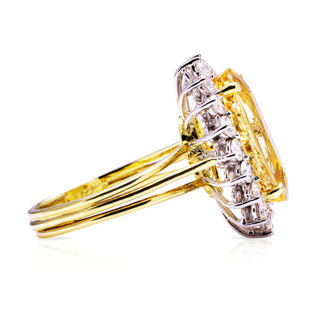 Imperial topaz and diamond cluster ring with gold band, side view.