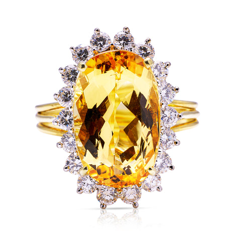 Imperial topaz and diamond cluster ring with gold band, front view.