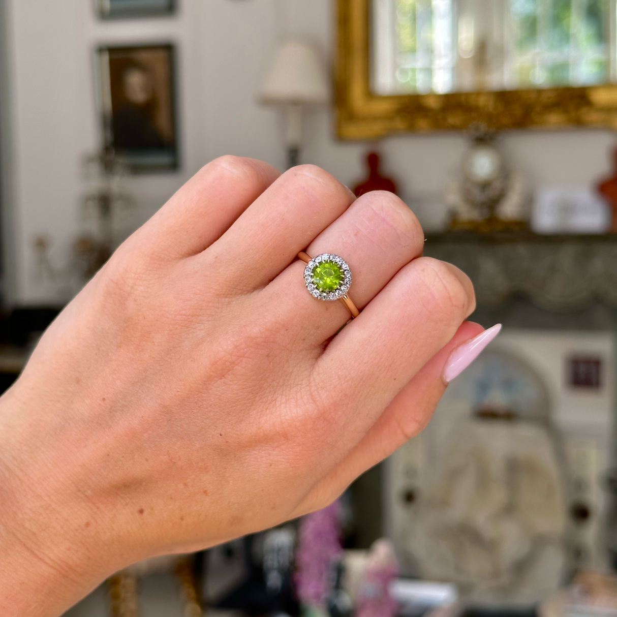 Edwardian peridot and diamond cluster ring,worn on closed hand.