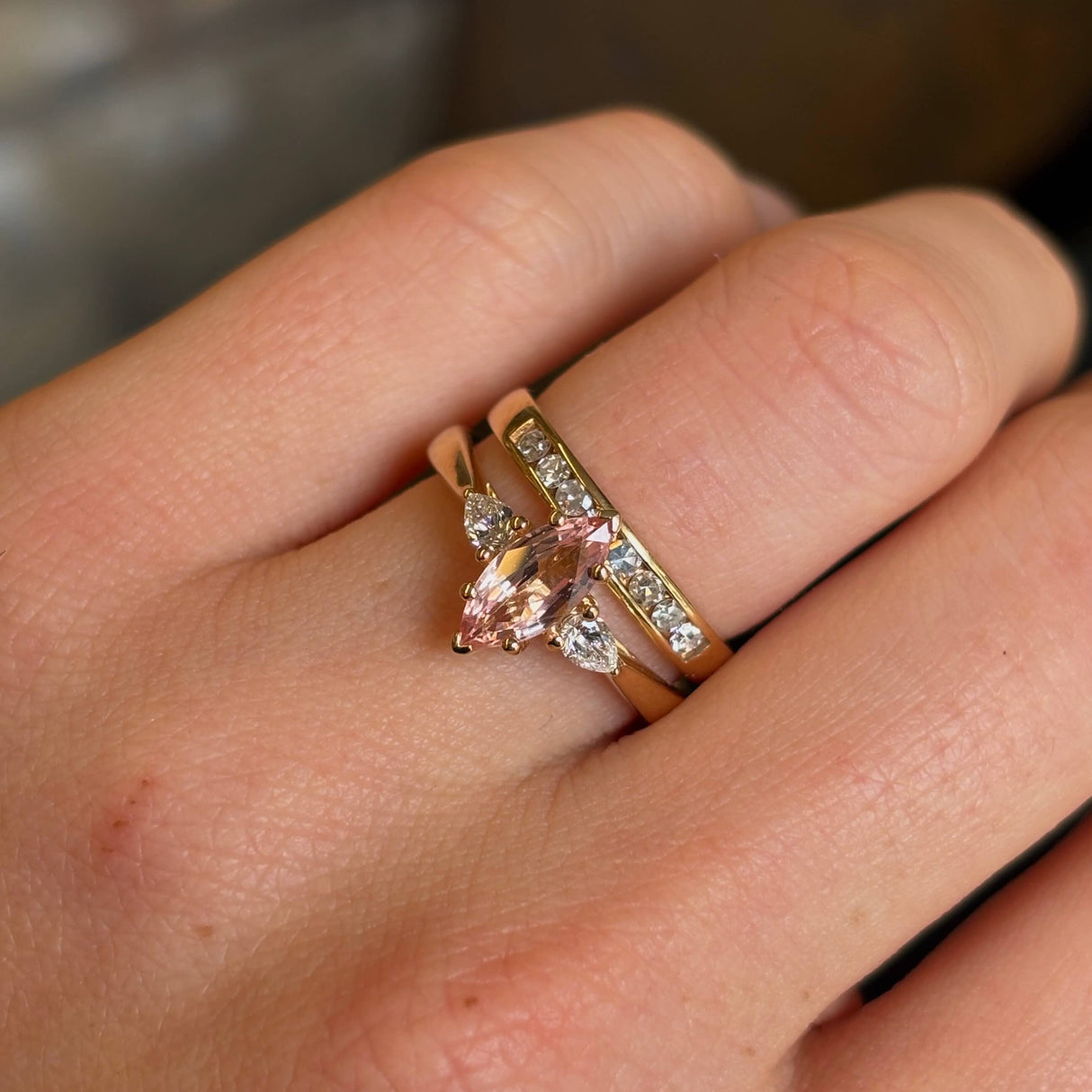 Pink Marquise-cut sapphire and diamond three-stone engagement ring stacked with wedding band to show proportions and fit. 