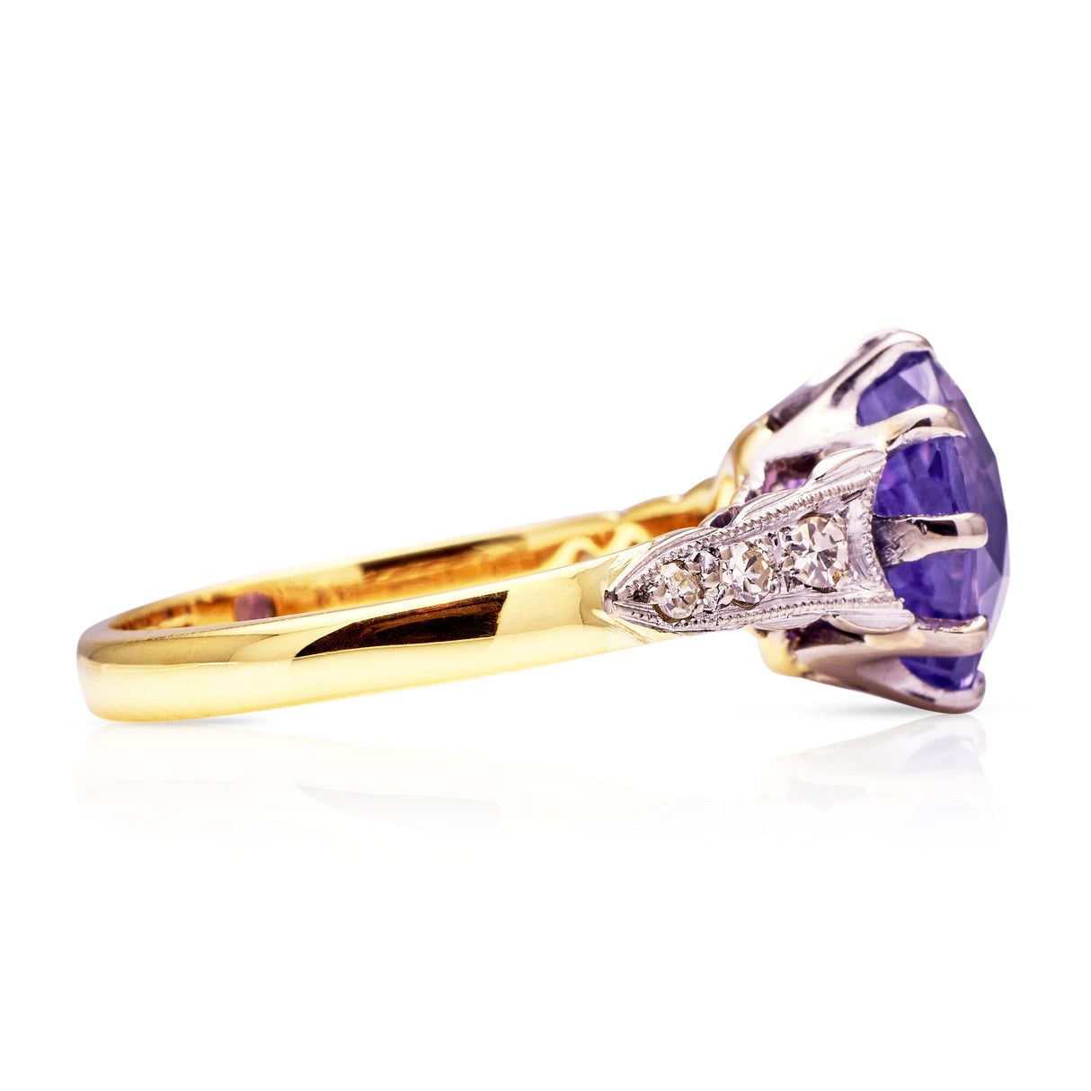 Purple sapphire engagement ring, side view.