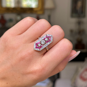 Antique ruby and diamond ring worn on closed hand. 