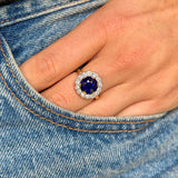 belle epoque sapphire and diamond cluster ring,  worn on hand placed in pocket of jeans,front view.