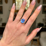 Art Deco sapphire and diamond ring worn on hand. 