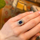 Sapphire and diamond antique cluster ring being worn on the hand