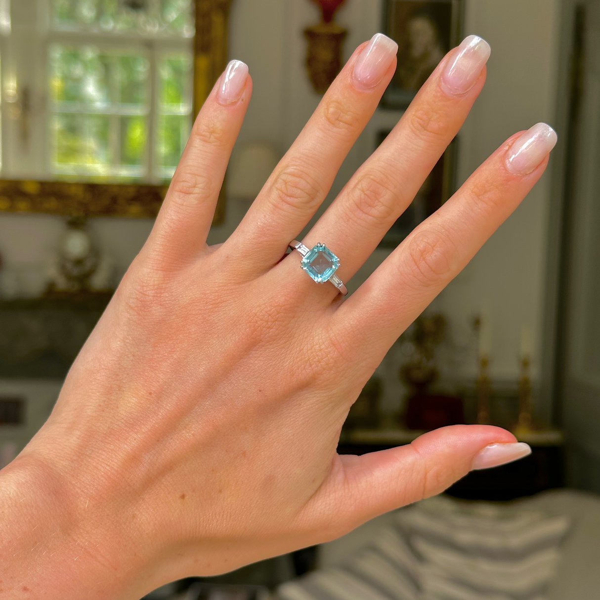 vintage aquamarine and diamond ring worn on hand. 