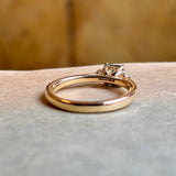 Hallmarks of Square-cut teal sapphire and diamond three-stone engagement ring.