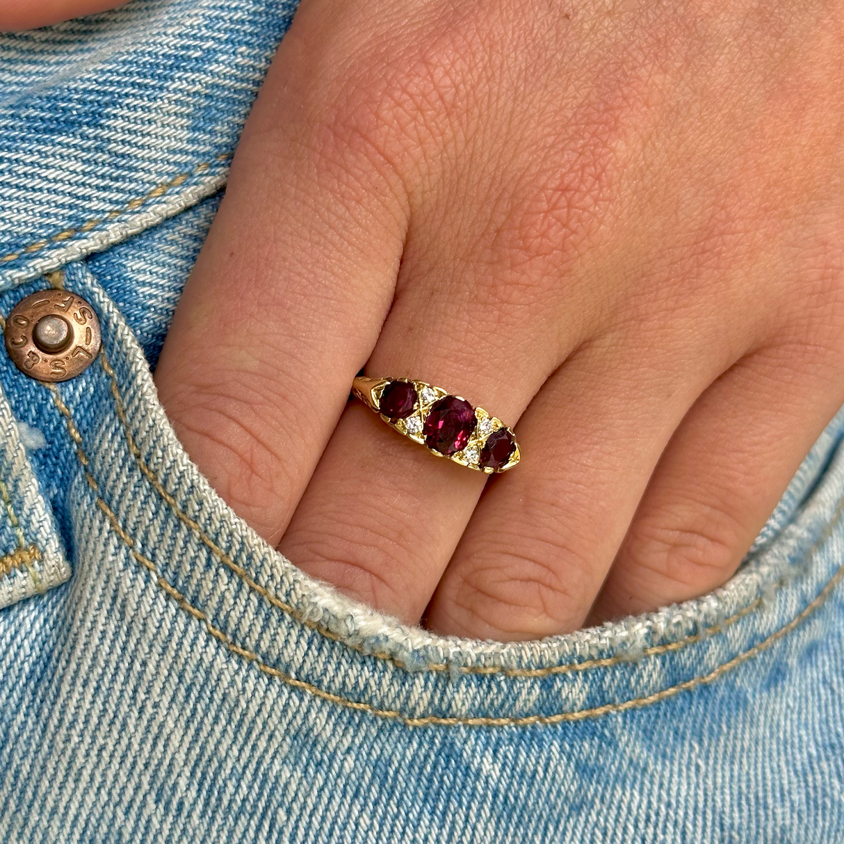 Antique Edwardian three stone ruby and diamond ring, worn on hand.