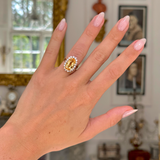 Imperial topaz and diamond cluster ring with gold band on hand