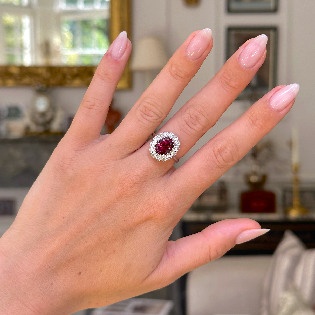 red tourmaline and diamond cluster ring, worn on hand,  front view. 