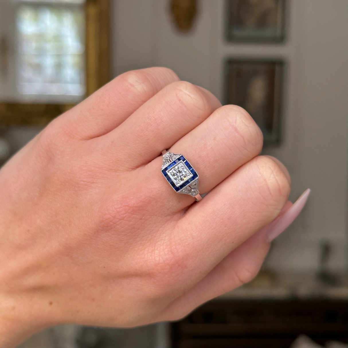 Vintage sapphire and diamond engagement ring, worn on hand. 