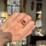 Victorian antique pink tourmaline ring worn on closed hand. 