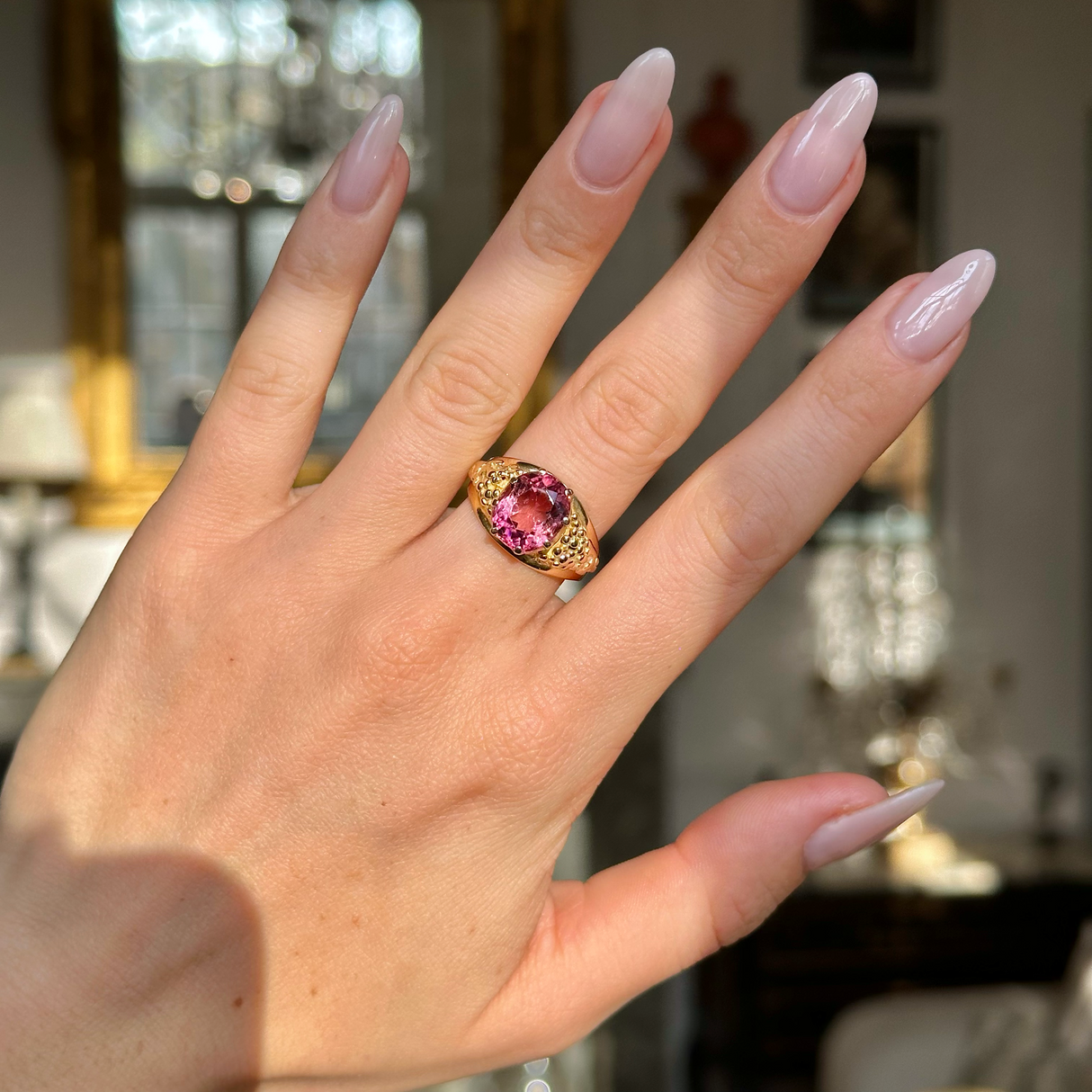Victorian antique pink tourmaline ring worn on hand. 