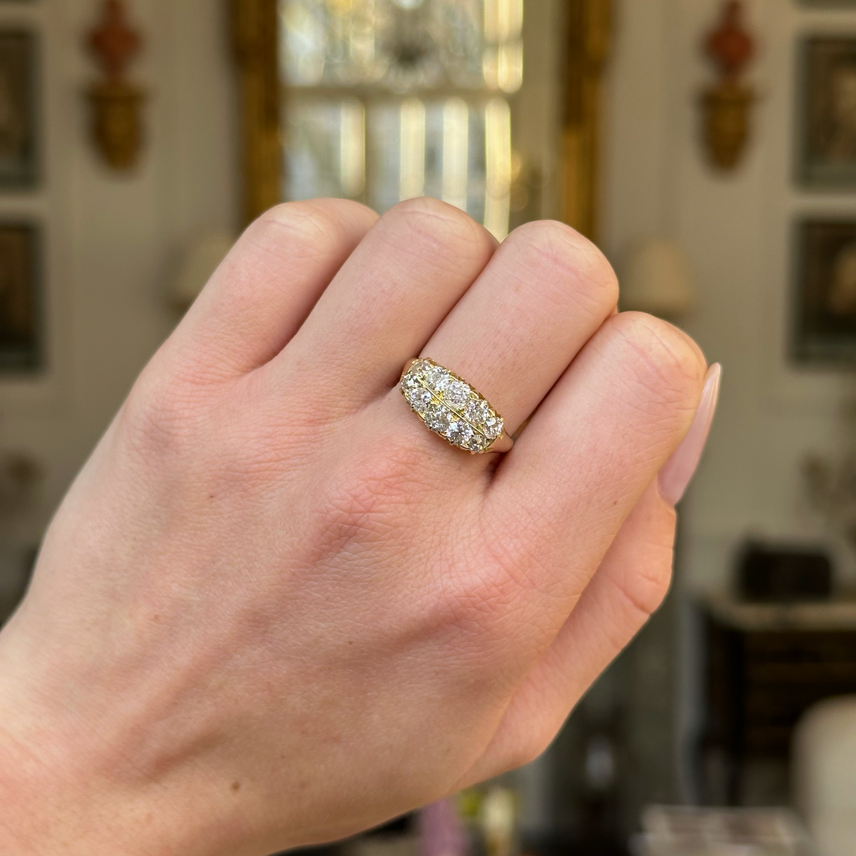 victorian double row diamond band worn on  closed hand. 