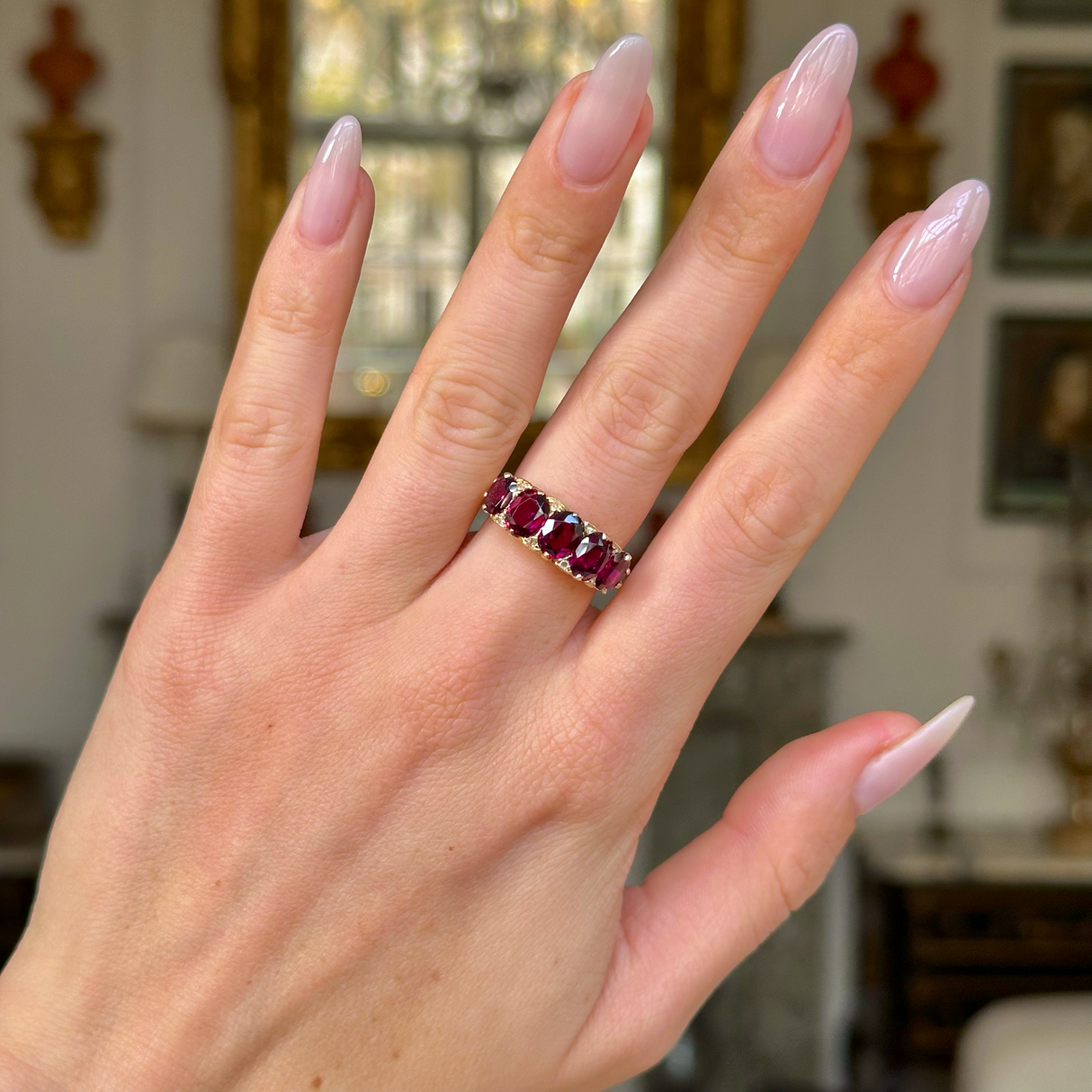 Victorian half hoop garnet ring worn on hand.