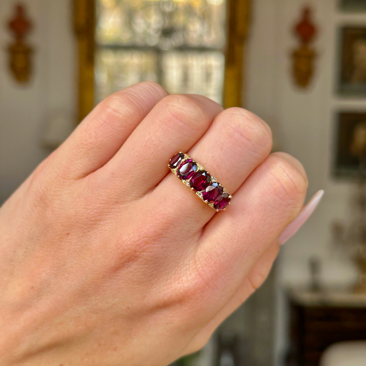 Victorian half hoop garnet ring worn on closed hand.