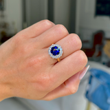 belle epoque sapphire and diamond cluster ring, worn on closed hand, front view.