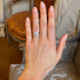 Vintage, 1980's diamond cluster ring captured on the ring finger of the left hand with a blurred background