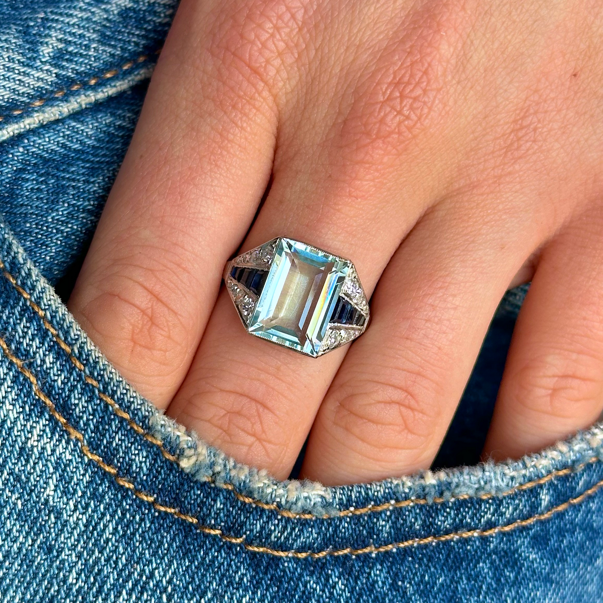 Vintage aquamarine,sapphire and diamond ring worn on hand in pocket of jeans