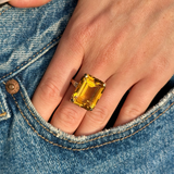 vintage cartier citrine cocktail ring worn on hand in pocket of denim jeans. 