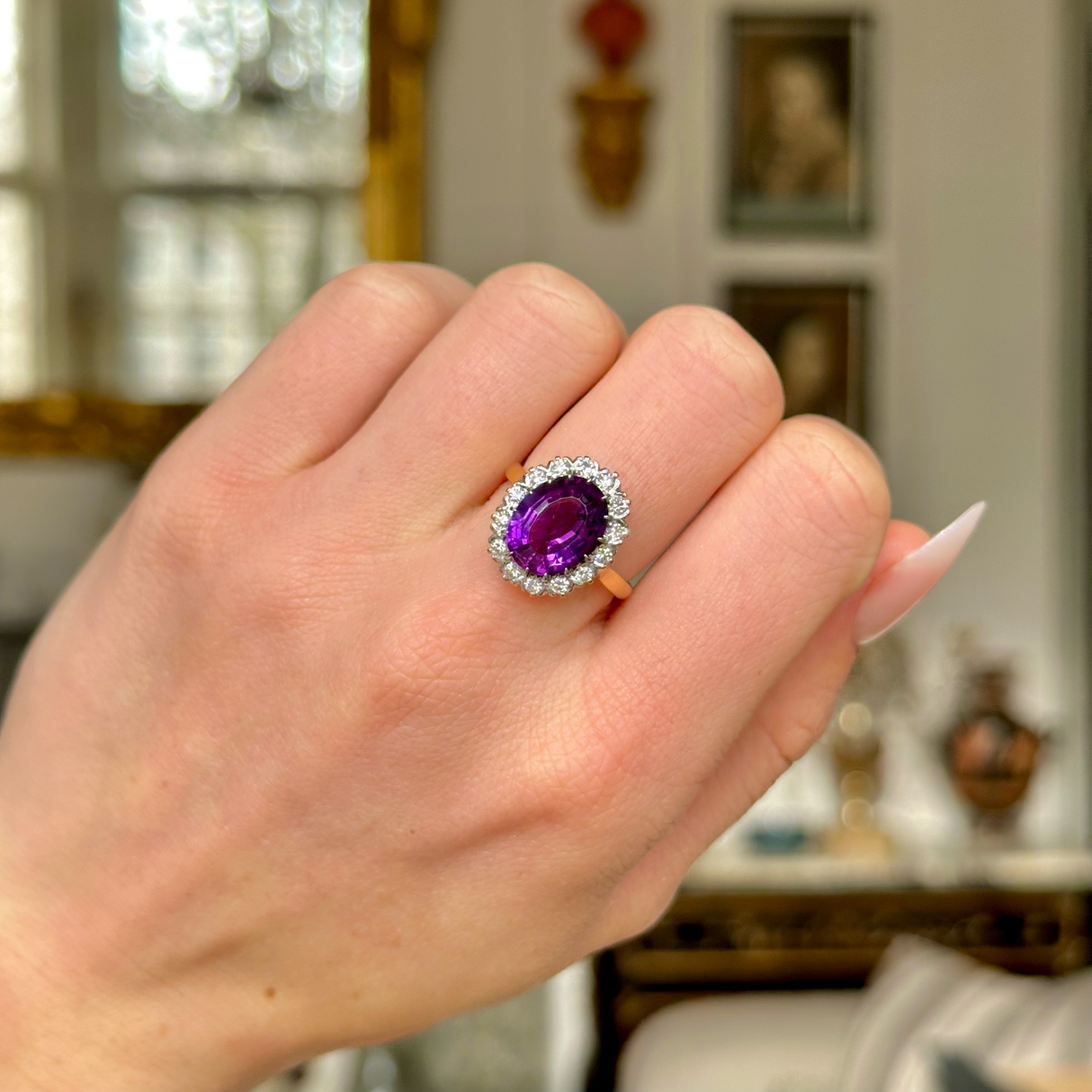 Vintage amethyst and diamond cluster ring, worn on closed hand. 