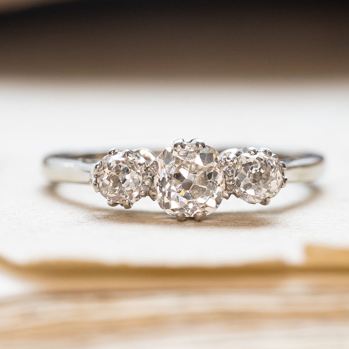 Vintage white gold old-mine cut three-stone diamond engagement ring. 
