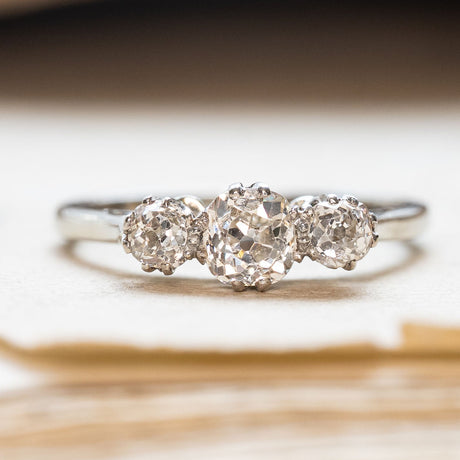 Vintage white gold old-mine cut three-stone diamond engagement ring. 