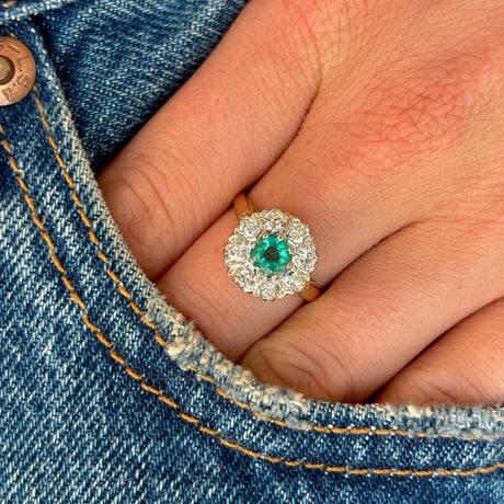 Vintage, 1980s emerald & diamond cluster ring worn on hand.