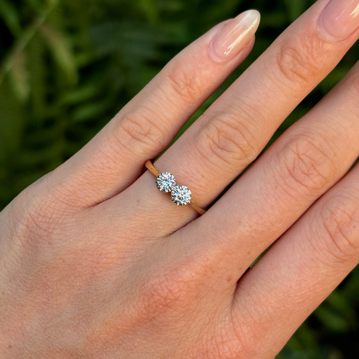 Vintage, 1990s diamond engagement ring worn on hand. 