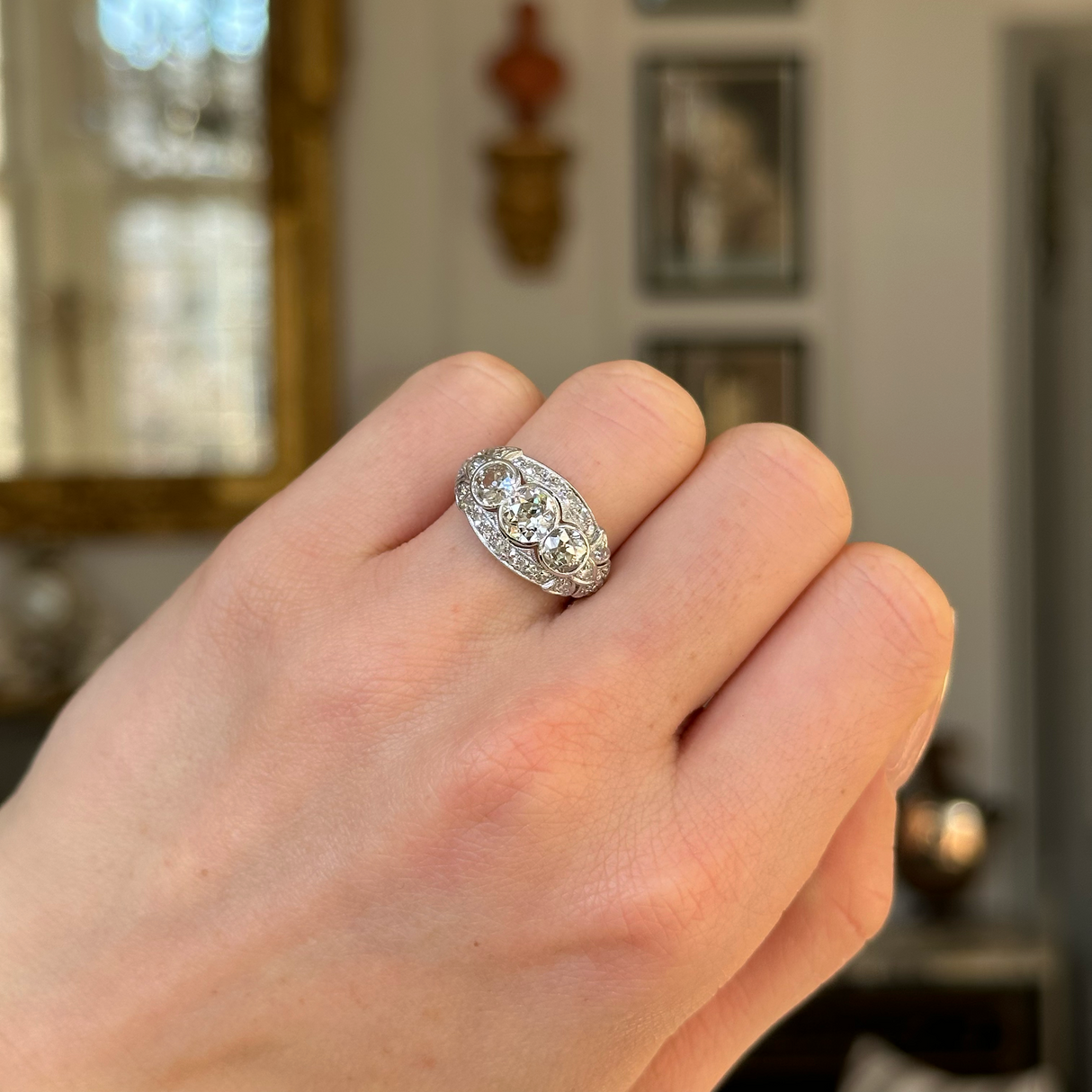 Vintage, Art Deco Diamond Three-Stone Engagement Ring, Platinum worn on closed hand. 