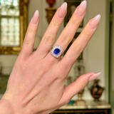 Art Deco sapphire and diamond cluster ring, worn on hand. 