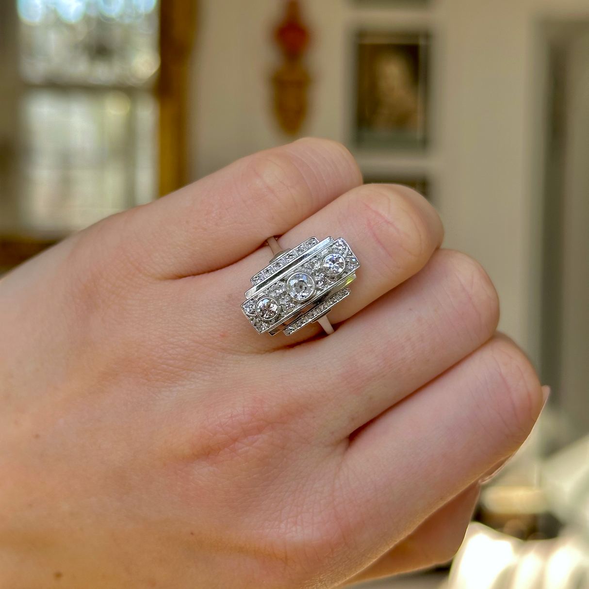 Vintage, Art Deco Three-Stone Diamond Panel Ring, Platinum worn on closed hand.