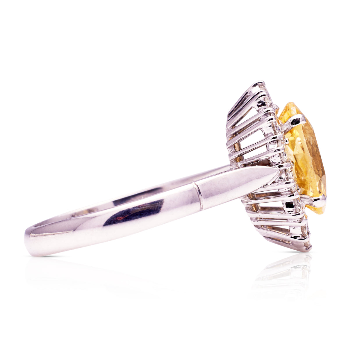 Yellow sapphire and diamond cluster engagement ring, side view. 