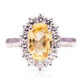 Yellow sapphire and diamond cluster engagement ring, front view. 