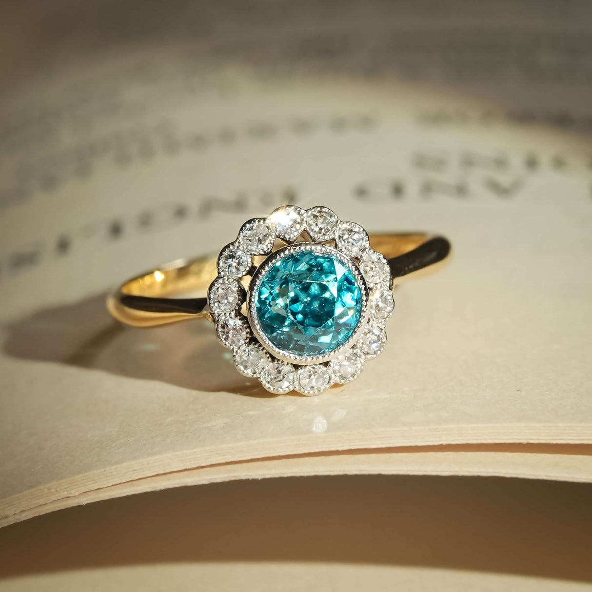 Antique 1920s zircon and diamond ring with round blue zircon and diamond halo