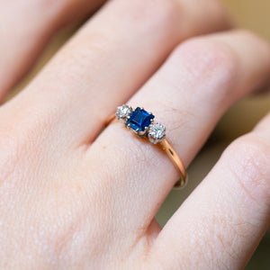 Detailed view of antique 1920s sapphire and diamond three-stone ring showing gemstone setting.