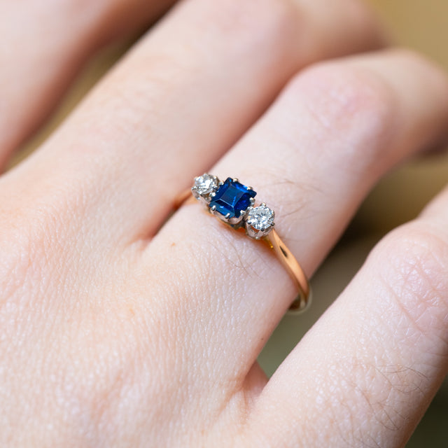 Detailed view of antique 1920s sapphire and diamond three-stone ring showing gemstone setting.