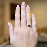 Antique 1920s sapphire and diamond three-stone ring worn on hand.
