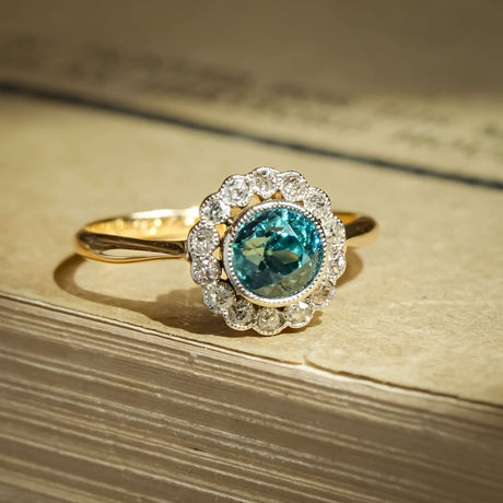 Antique 1920s zircon and diamond cluster ring with round blue zircon and diamond halo