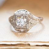 Antique Art Deco diamond cluster ring with old-cut diamond and intricate filigree detailing.
