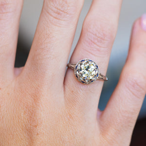 Antique Art Deco ring showing central diamond and surrounding cluster detail.