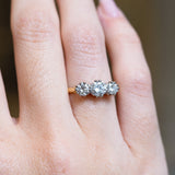 Antique Art Deco diamond three-stone ring with graduated diamond setting and yellow gold band.