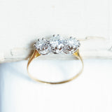 Antique Art Deco diamond three-stone ring showing detailed diamond setting and gold band.
