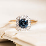 Antique Art Deco sapphire and diamond cluster ring with a deep blue step-cut sapphire and diamond halo.