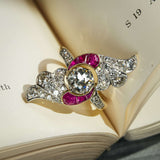 Antique Art Nouveau diamond and ruby cocktail ring with central diamond and curved ruby accents