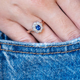 Antique Belle Époque sapphire and diamond cluster engagement ring styled with denim pocket.